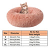 A fluffy pink pet bed shaped like a burrow for dogs and cats.