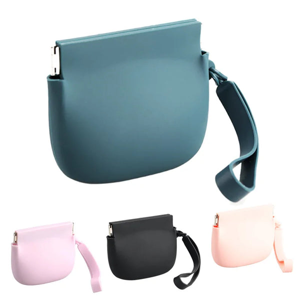 A collection of odorless silicone dog treat pouches in pink, gray, and black with adjustable straps.
