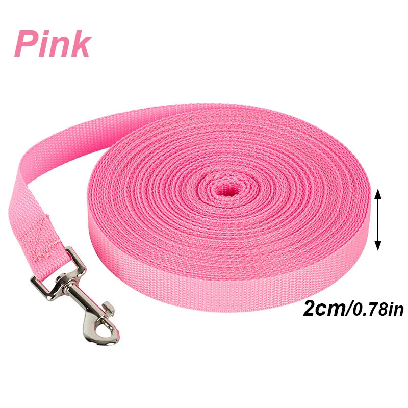 Pink nylon dog training leash in a roll with a metal clip visible.