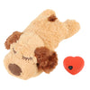 A light brown stuffed animal resembling a dog's head with brown ears and a small orange heart-shaped button.