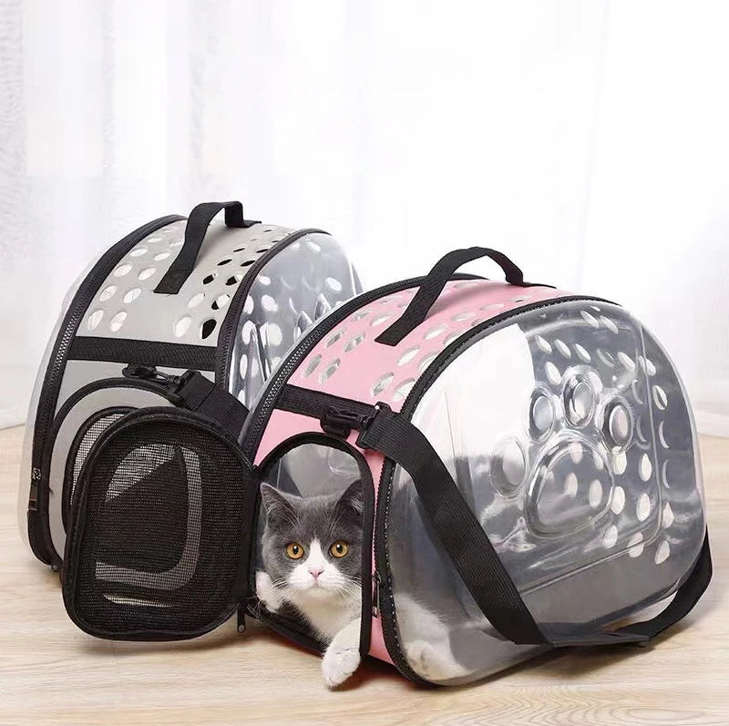 A transparent foldable pet travel carrier with a gray and pink design shown from above.