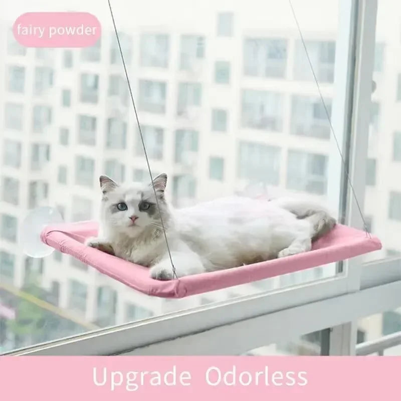 A white cat is relaxing in a pink cozy window hammock, labeled as fairy powder.