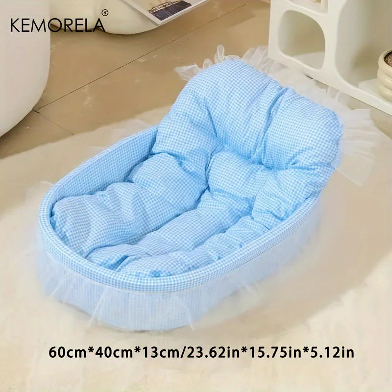 Light blue quilted pet bed mat with sheer trim shown on a white surface.