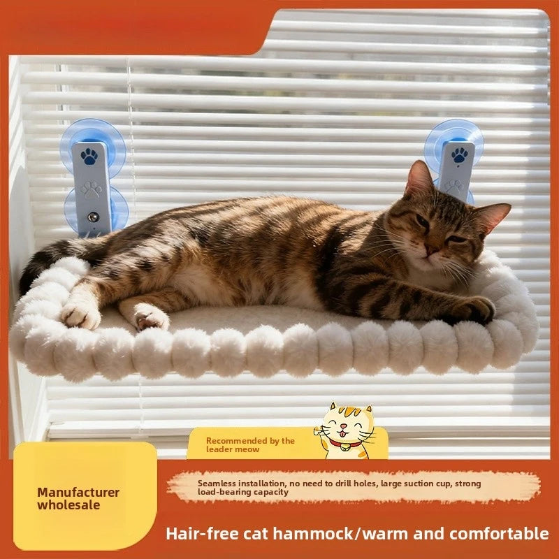 A tabby cat relaxing on a white fluffy hammock designed for a window perch, recommended by the leader meow.