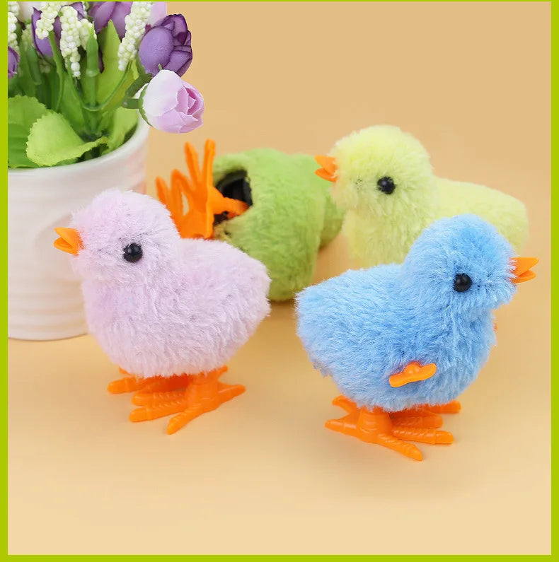 A collection of colorful wind-up plush toys shaped like chicks and cats in pink, green, yellow, and blue.