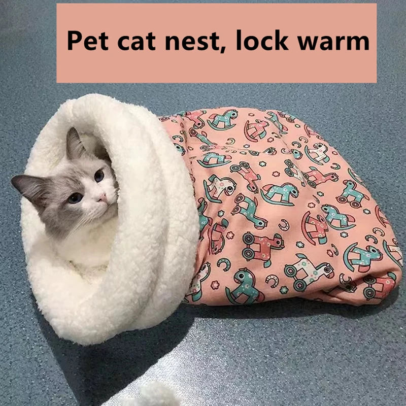 A fluffy white cat is nestled inside a pink patterned pet cat nest designed to keep the cat warm.