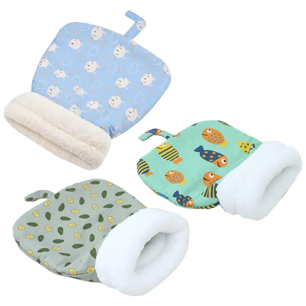 A set of two plush sleeping bags featuring a light blue pattern with cats and dogs, and a green pattern with various animals.