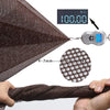 A close-up view of a dark brown durable safety mesh material being held, with a digital scale showing 100.00 kg.