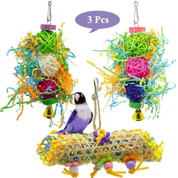 Three colorful parrot shredder toys made of natural wood and fibers hanging by strings.