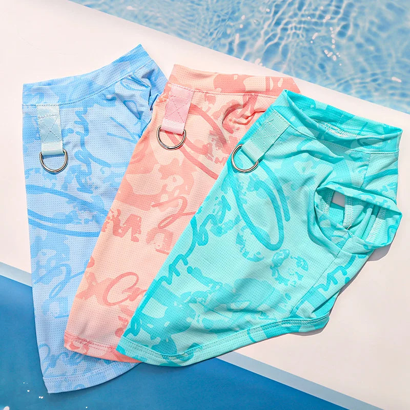Three brightly colored ice silk cooling vests for dogs and cats laid out on a white surface.