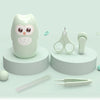 A light green kids portable nail care set featuring a cute owl-shaped tool and various manicure instruments.