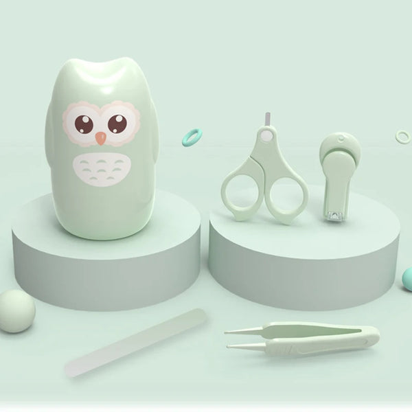 A light green kids portable nail care set featuring a cute owl-shaped tool and various manicure instruments.