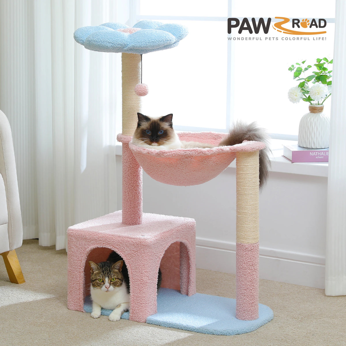 A pink and beige decorative cat tree with sisal scratching posts and a blue platform for a cat.