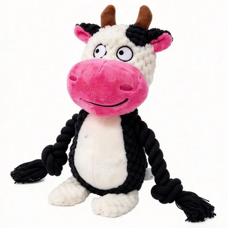 A plush animal toy resembling a cow with pink face and black hair rope features for interactive play