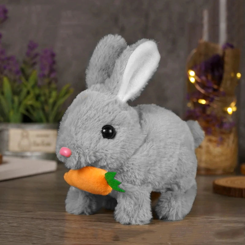 A gray plush bunny toy with pink nose and orange carrot, sitting on a wooden surface.