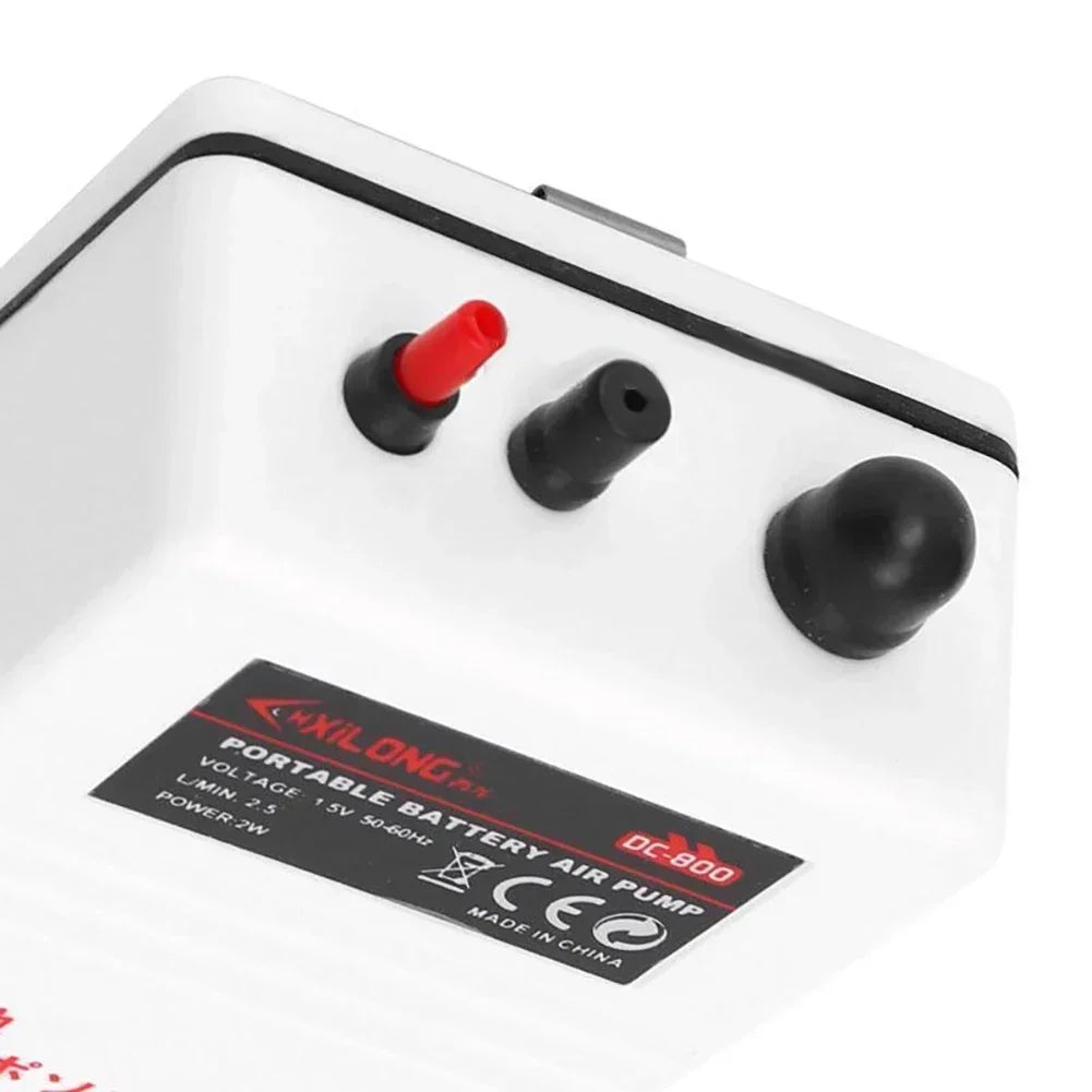 A white portable battery air pump with three black and red buttons and a label indicating DC-800 power.