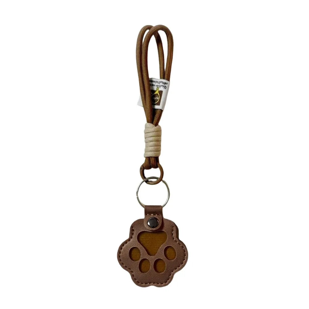 Brown refillable pet hair keychain with a cat paw charm and leather strap
