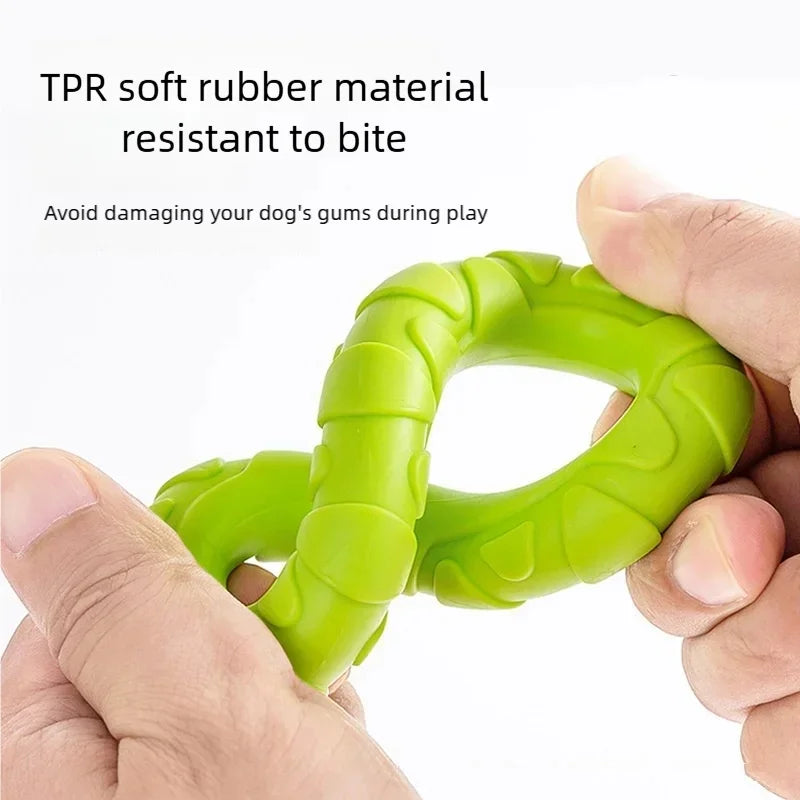 A hand holds a bright green TPR soft rubber pull ring dog chew toy designed for dental health and interactive play.