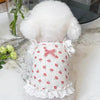 A white knitted pet vest for dogs or cats featuring a floral print and lace trim.