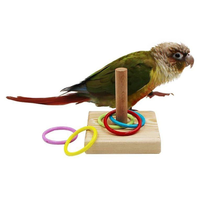 A small bird toy featuring a realistic depiction of a bird with green and brown plumage, perched on a wooden block with color
