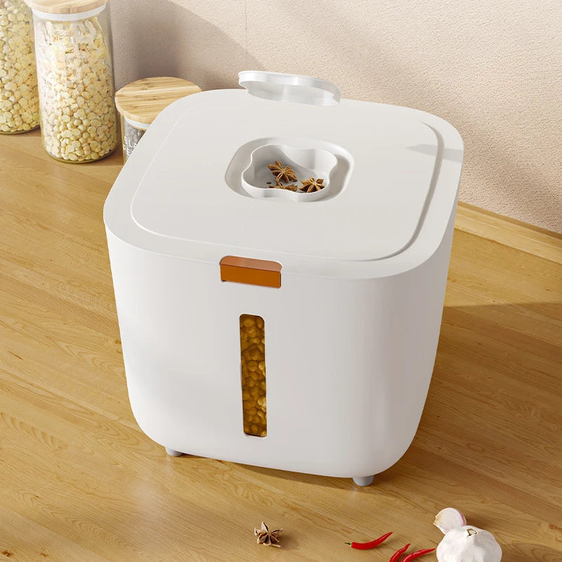 A white airtight pet food storage bucket with an open lid and a vertical orange-brown seal, sitting on a wooden surface.