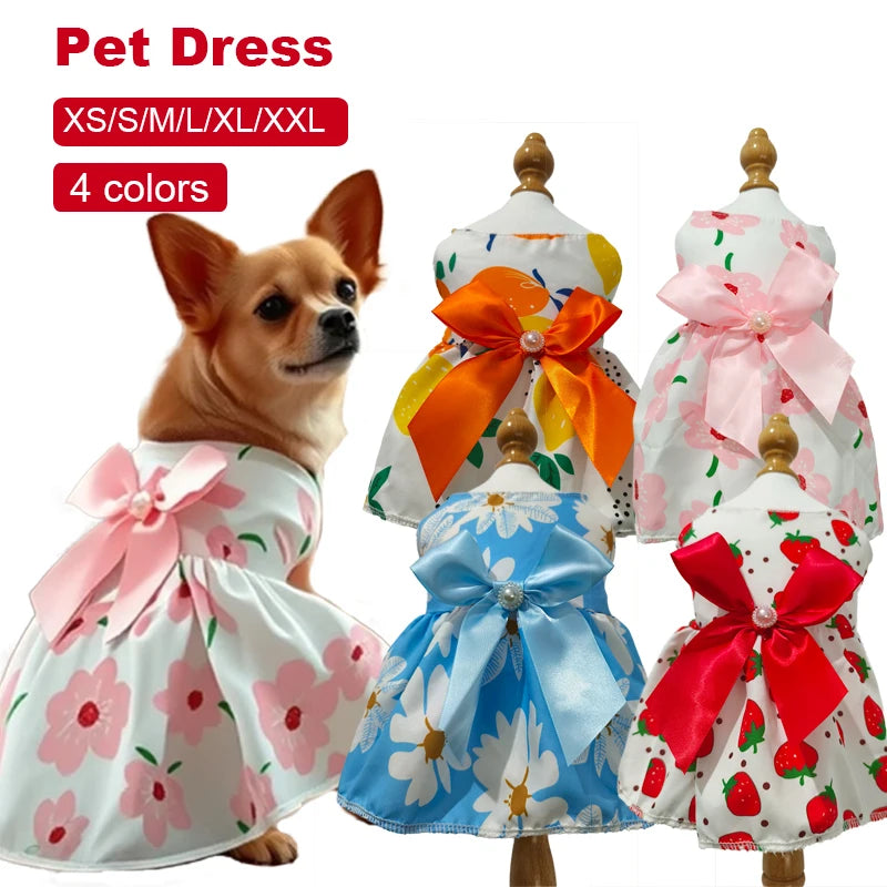 A collection of four pet dresses in various colors and patterns for small to medium dogs, featuring lace and bows.
