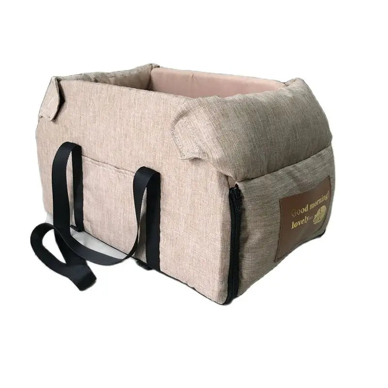 A beige portable pet car seat carrier for small dogs and cats with black straps.