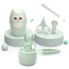 A light green portable nail care set featuring a owl-shaped container, scissors, and a small grooming tool.