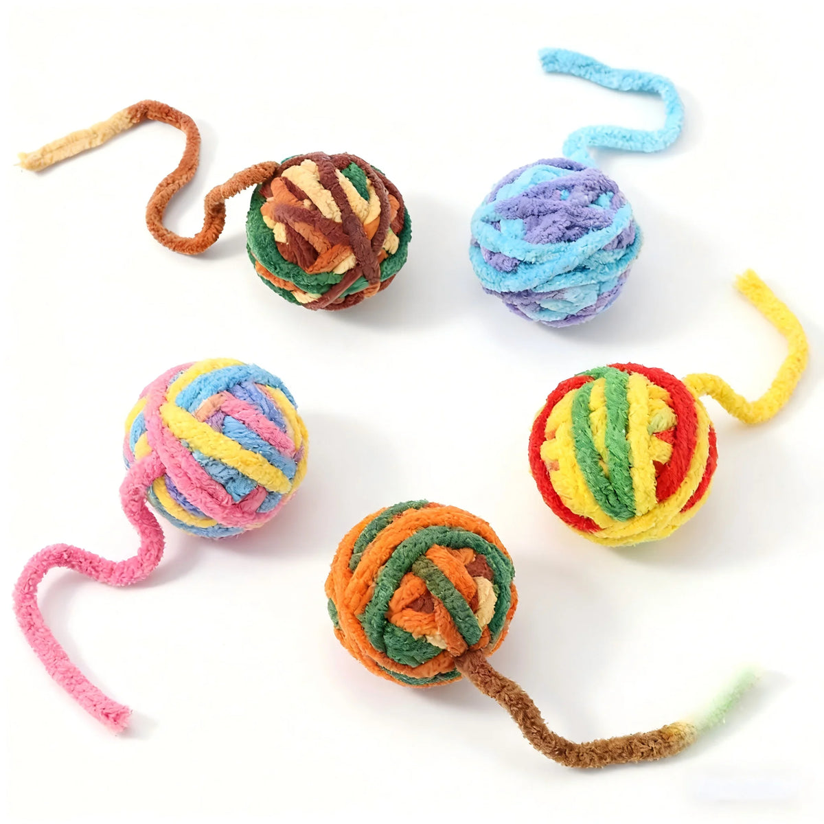 A collection of soft plush cat toys in various colors and textures, including balls and string toys.