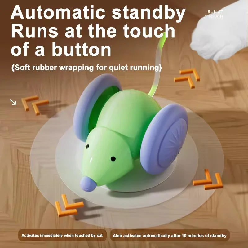 A green and purple interactive electric mouse toy shaped like a cat, shown on a wooden surface.