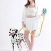 A woman is holding a yellow adjustable hands-free dog leash attached to a spotted dog.