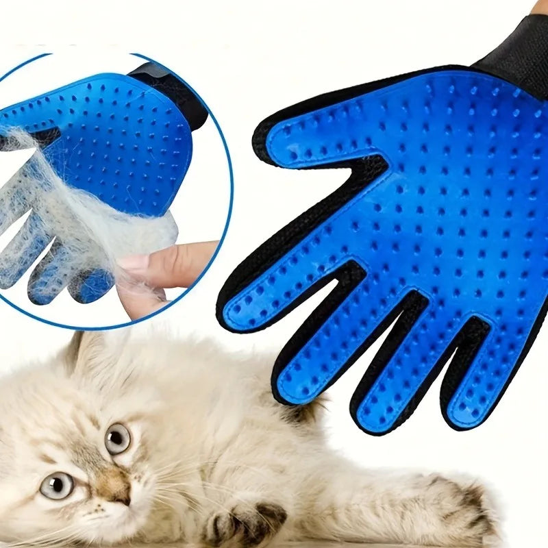 Blue pet massage cleaning gloves being used on a kitten.