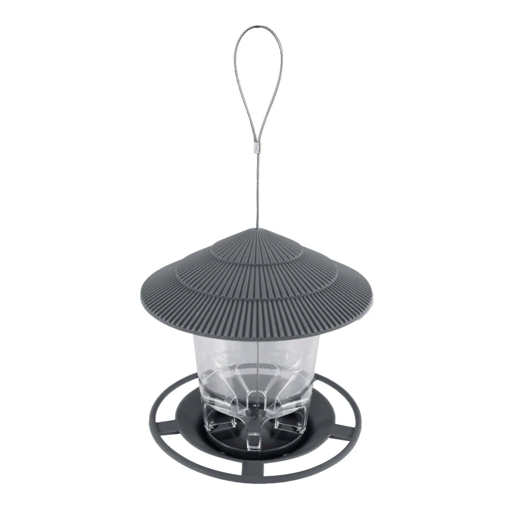 A window-mounted bird feeder with a clear viewing panel and a metal hanging wire.