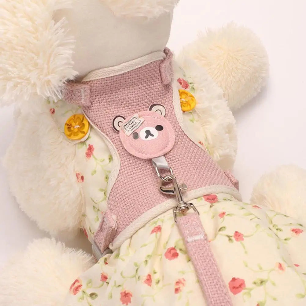 A pink and cream pet leash harness for dogs and cats with fluffy white trim.