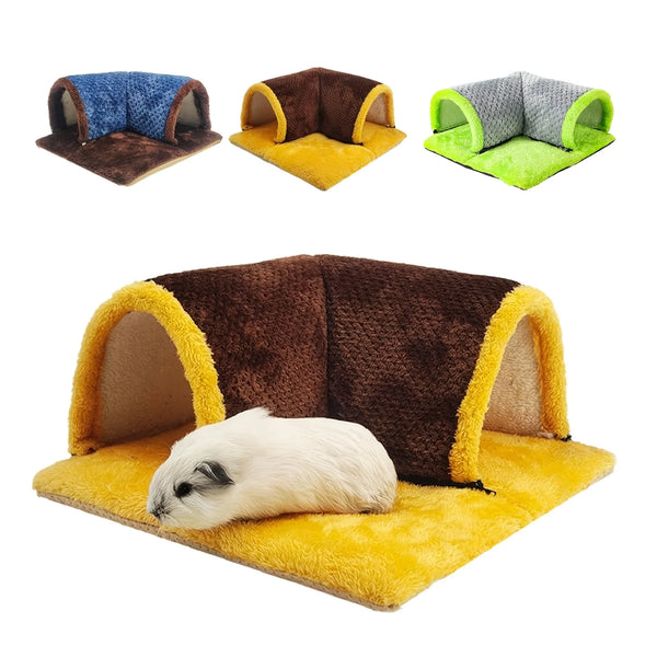 A fluffy white guinea pig is resting inside a brown and yellow cozy corner hideout tunnel.