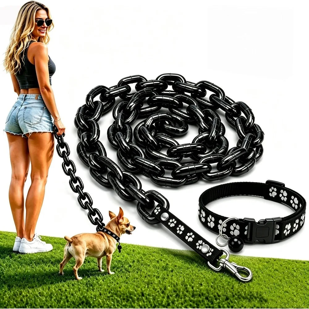A woman stands next to a dog while a black faux chain dog leash and collar are displayed on green grass.