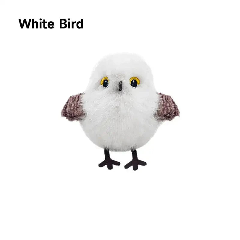 A white bird toy with brown wings and yellow eyes, designed for interaction.