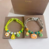 Colorful braided pet collar with bell featuring yellow, green, and orange beads for cats and small dogs.