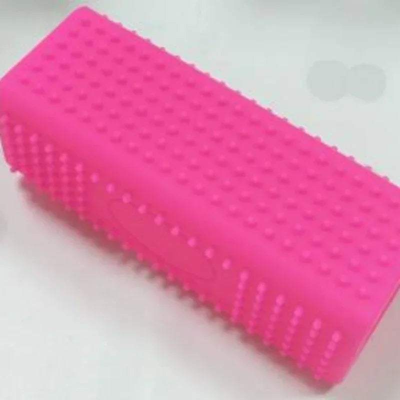 A bright pink silicone pet hair remover brush with textured bristles.