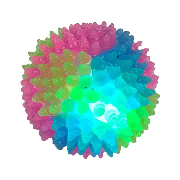 An interactive glowing fetch ball for pets, featuring a textured surface with multiple colors including pink, green, and blue