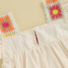 A light beige floral embroidery toddler romper with colorful fabric accents.