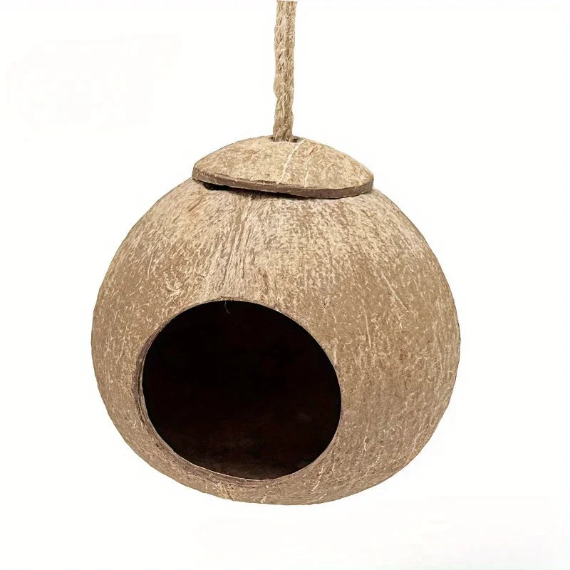 A natural coconut shell bird nest hanging by a string.