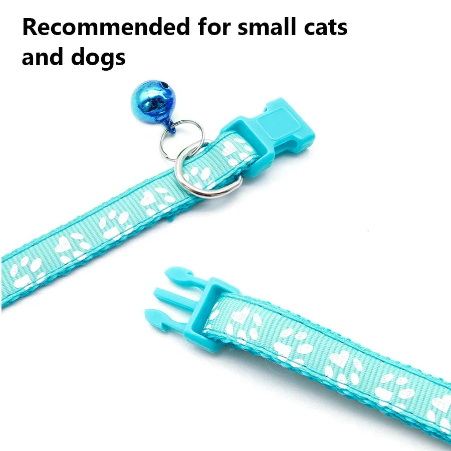 A turquoise adjustable pet collar with a blue bell and a white patterned strap for small pets.
