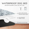 A waterproof dog bed featuring a soft plush cover, inner layer, and non-slip bottom on a wooden floor.