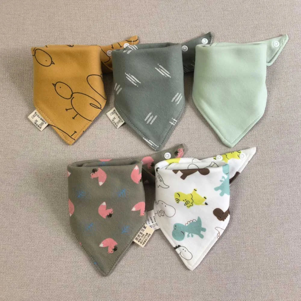 A set of five cotton triangle baby bibs featuring various cartoon prints in yellow, gray, and light green.