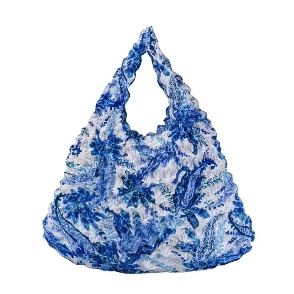 A blue and white floral patterned fabric tote bag