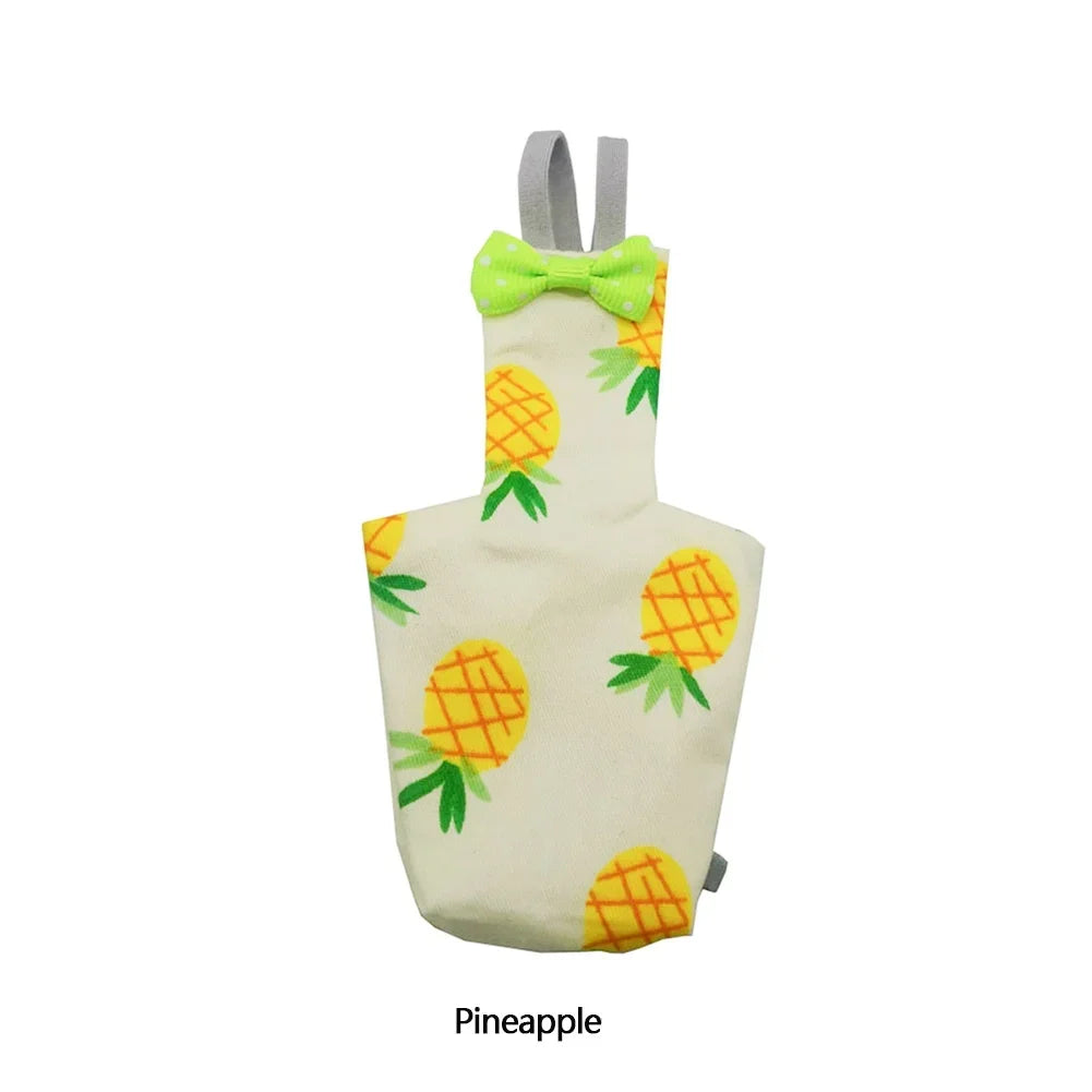 A light yellow diaper flight suit featuring a floral pattern of pineapple motifs and a lime green bow.