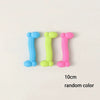 Three bone-shaped rubber chew toys in blue, green, and pink for small dogs
