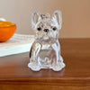 Clear glass figurine of a dog sitting, used as a keychain.