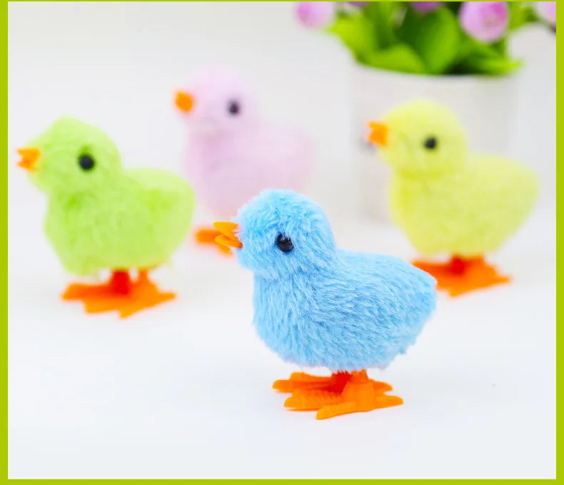 A collection of colorful wind-up plush chick toys in green, pink, yellow, and blue.